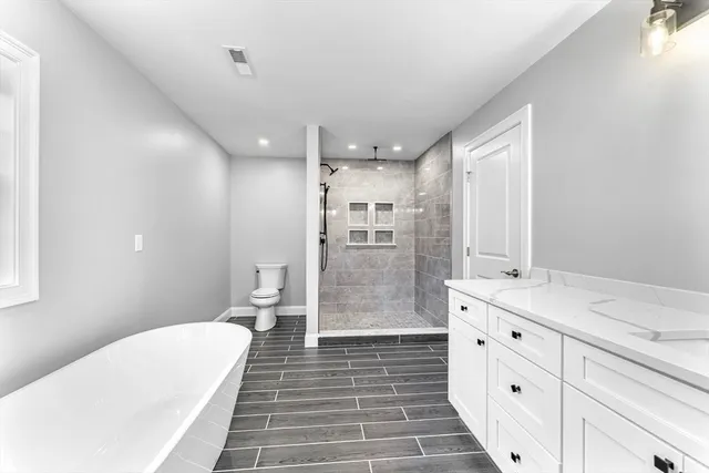 a view of a room with wooden floor and window