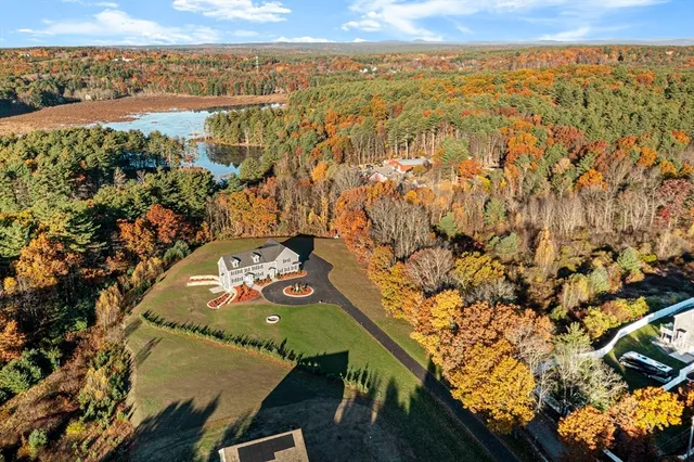 an aerial view of a house with a yard