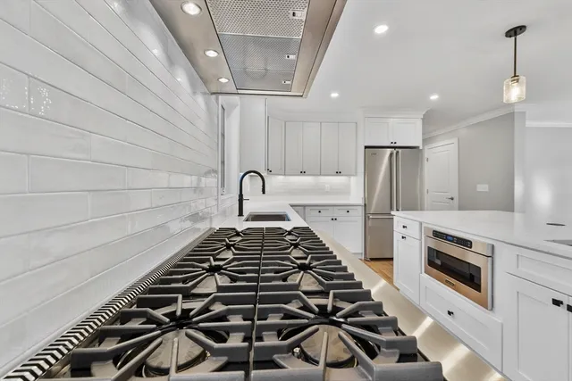 a view of empty room with wooden floor and fireplace