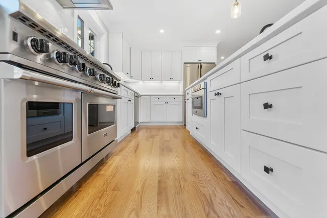 a view of a living room kitchen with stainless steel appliances kitchen island