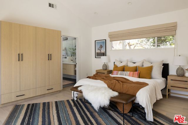 a bedroom with bed and a window