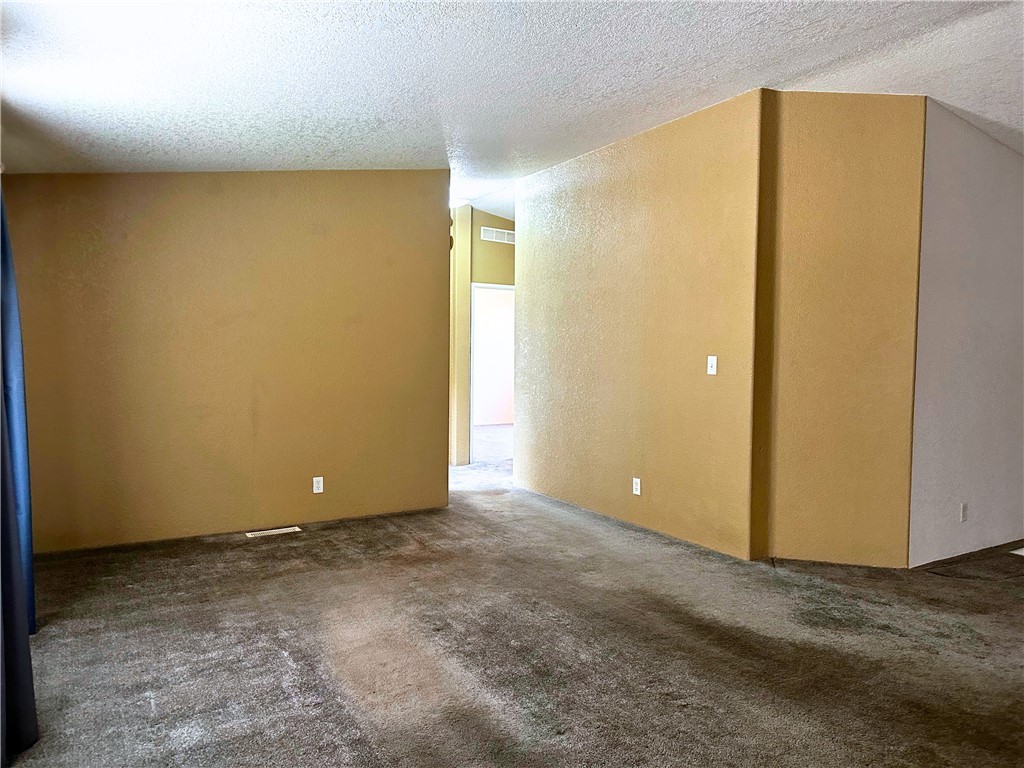 3746 Bouse Road Golden Valley, AZ 86413 - Photo 25 of 53 Carpeted empty room with a textured ceiling and a textured wall