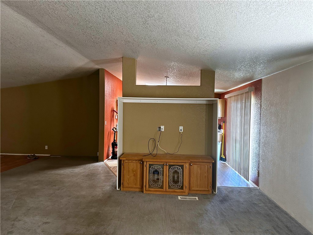 3746 Bouse Road Golden Valley, AZ 86413 - Photo 27 of 53 Bonus room featuring a textured ceiling, carpet floors, and a textured wall