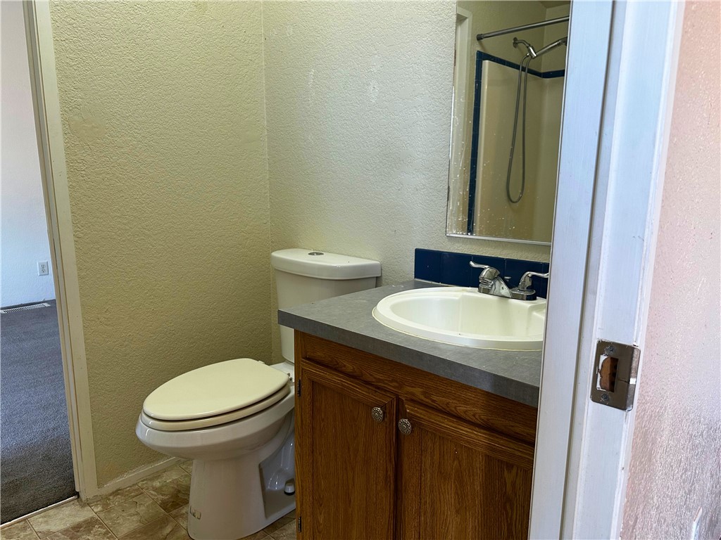 3746 Bouse Road Golden Valley, AZ 86413 - Photo 29 of 53 Bathroom featuring a textured wall and vanity