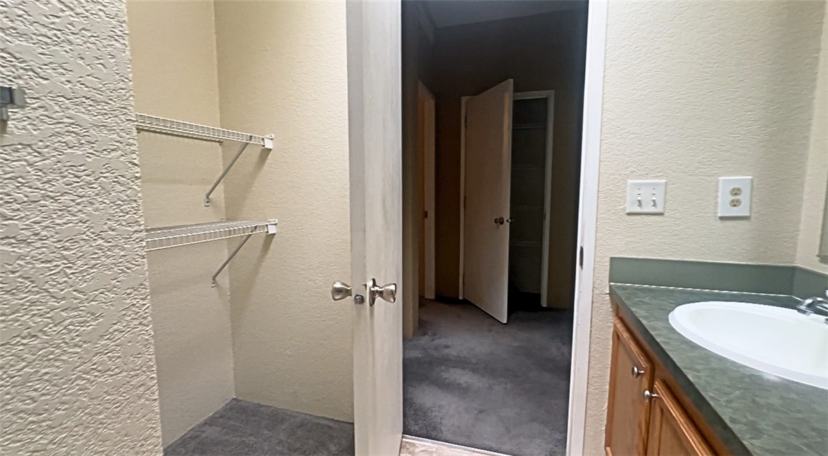3746 Bouse Road Golden Valley, AZ 86413 - Photo 35 of 53 Bathroom featuring a textured wall and vanity