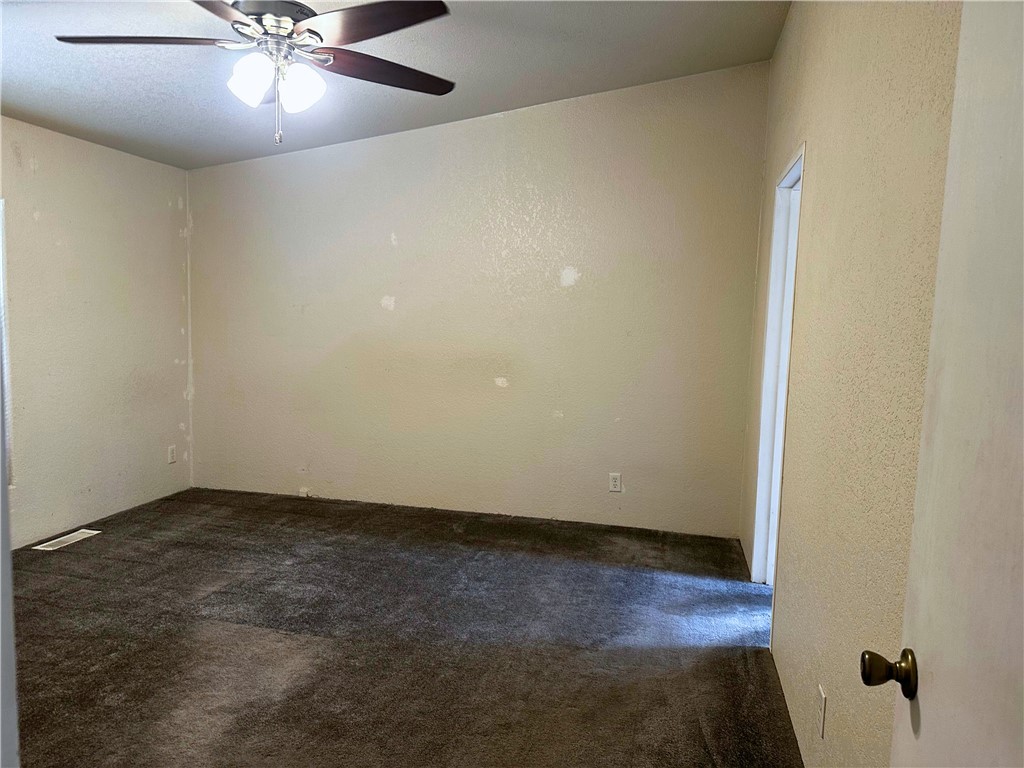 3746 Bouse Road Golden Valley, AZ 86413 - Photo 36 of 53 Carpeted empty room featuring a textured wall and ceiling fan