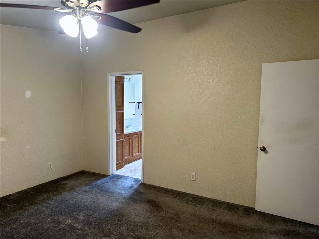 3746 Bouse Road Golden Valley, AZ 86413 - Photo 38 of 53 Unfurnished room with dark carpet, a textured wall, and a ceiling fan