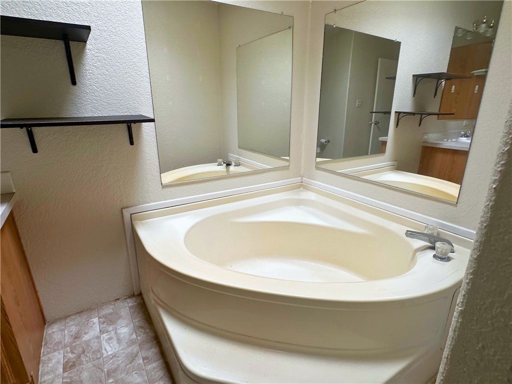 3746 Bouse Road Golden Valley, AZ 86413 - Photo 40 of 53 Full bath with a textured wall, vanity, and a garden tub
