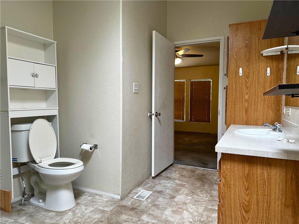 3746 Bouse Road Golden Valley, AZ 86413 - Photo 41 of 53 Bathroom with a textured wall, vanity, and ceiling fan