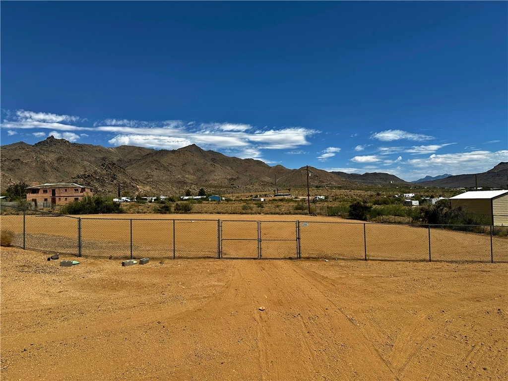 3746 Bouse Road Golden Valley, AZ 86413 - Photo 46 of 53 View of yard with a gate, a mountain view, and a rural view