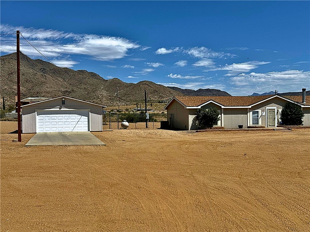 3746 Bouse Road Golden Valley, AZ 86413 - Photo 51 of 53 Single story home with a mountain view, an outdoor structure, and a garage
