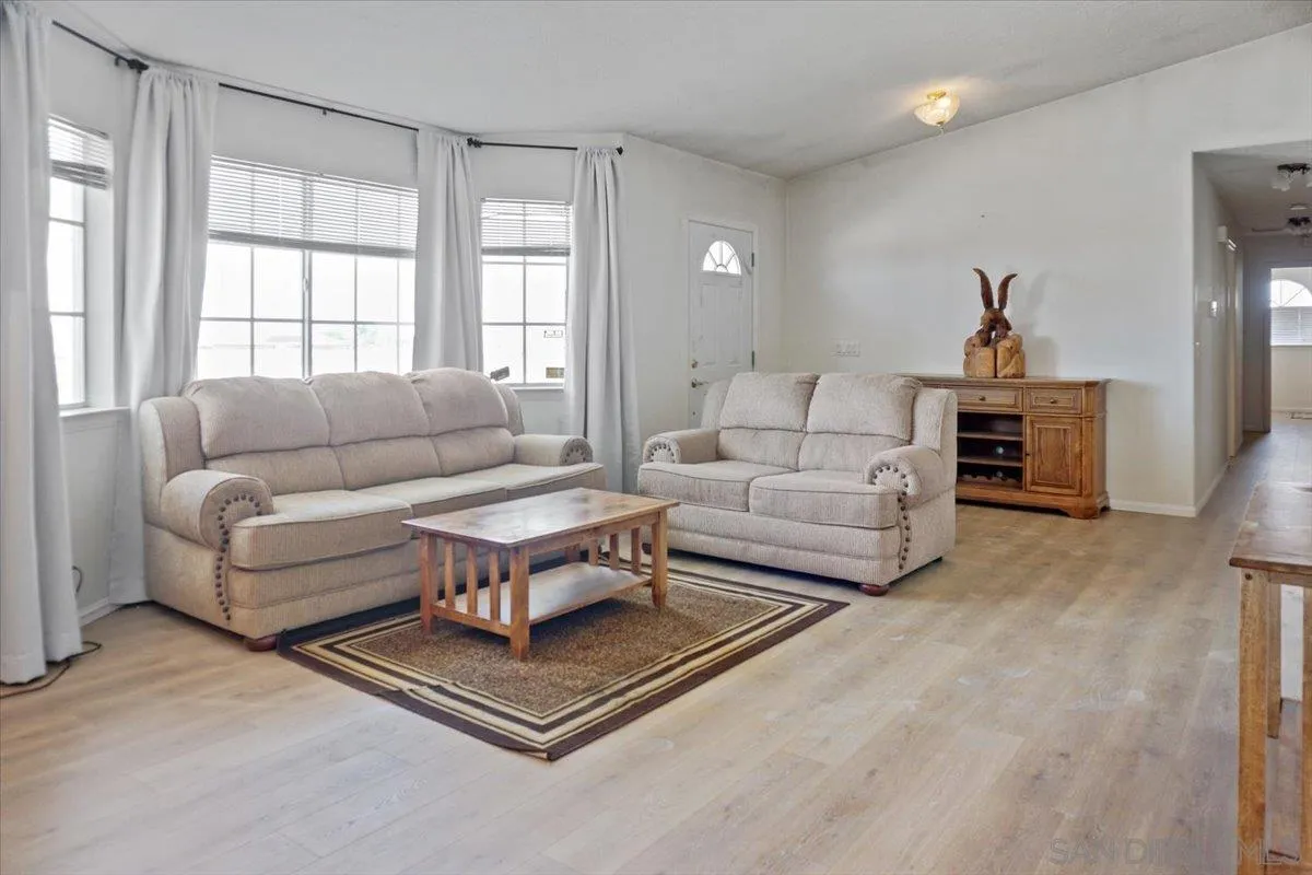 28525 Windy Pass Barstow, CA 92311 - Photo 11 of 40 a living room with furniture a flat screen tv and a large window