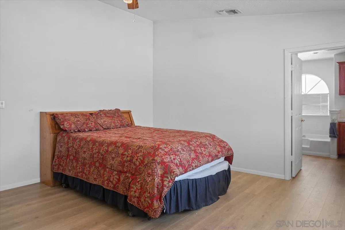 28525 Windy Pass Barstow, CA 92311 - Photo 18 of 40 a bedroom with a bed and wooden floor