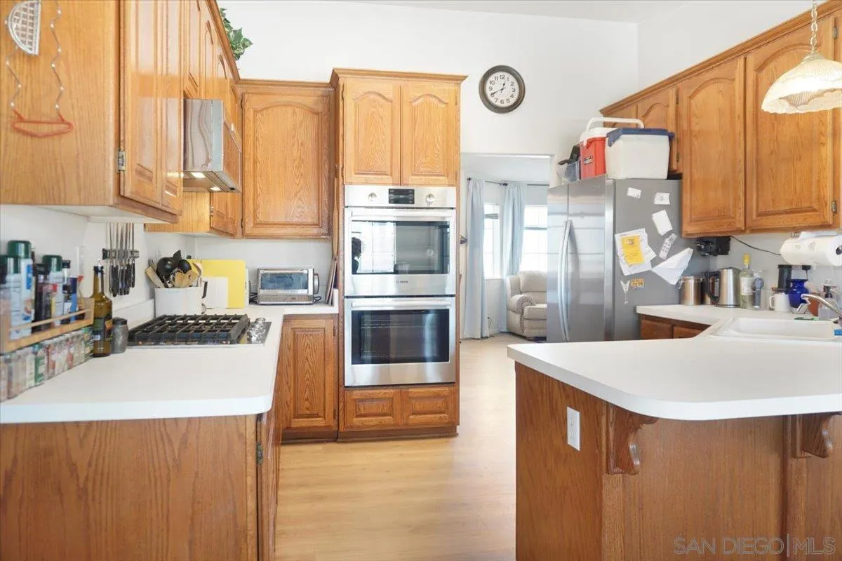 28525 Windy Pass Barstow, CA 92311 - Photo 32 of 40 a kitchen with stainless steel appliances a stove a sink and a refrigerator