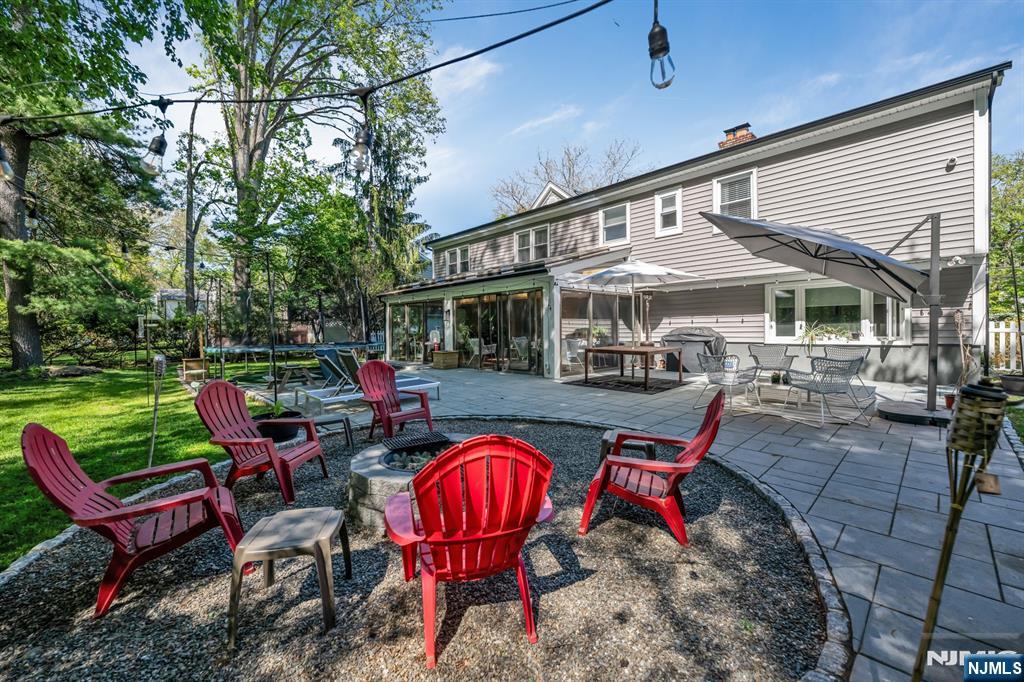 433 Piermont Road Cresskill, NJ 07626 - Photo 40 of 49 a view of a swimming pool with sitting area