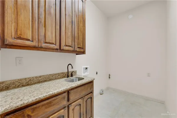 a kitchen with granite countertop white cabinets and a sink