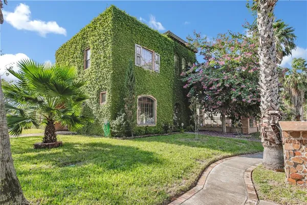 a front view of a house with garden