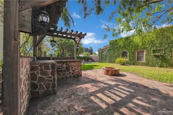 a view of a chairs and table in backyard of the house