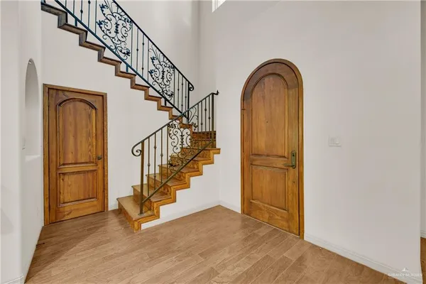 a view of entryway with wooden floor and stairs