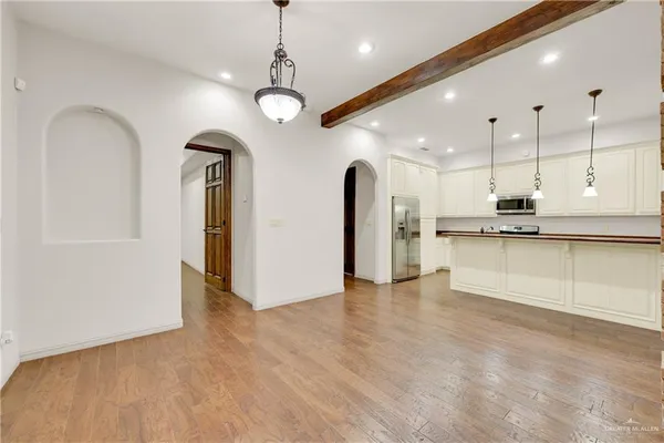 a view of kitchen with refrigerator and window