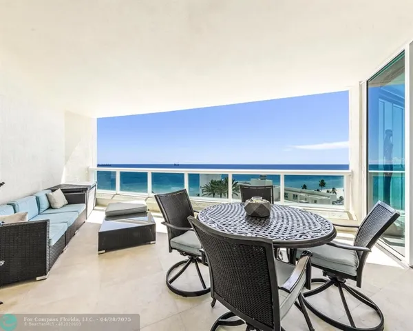 a view of a patio with a table and chairs