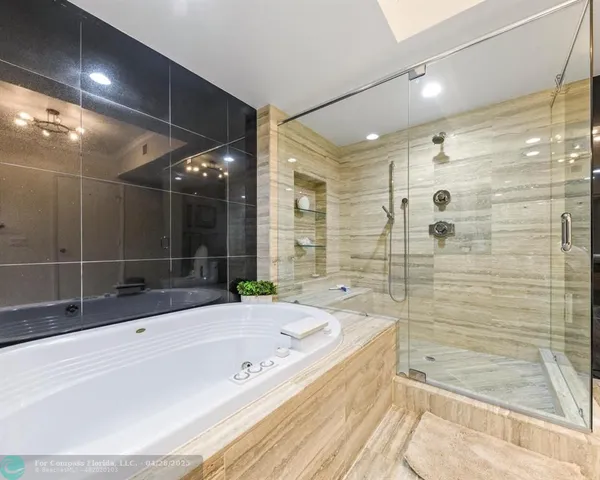 a bathroom with a bathtub and a shower