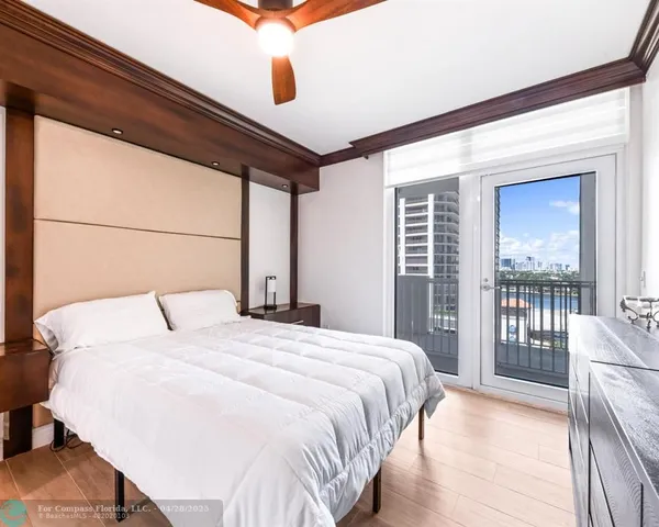 a bedroom with a large bed and a large window