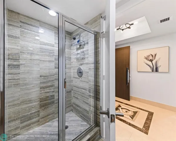 a bathroom with a shower and a sink