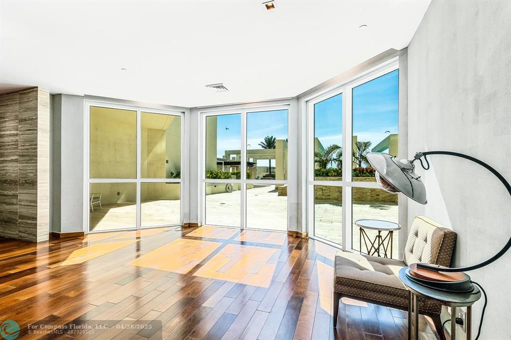 101 South Fort Lauderdale Beach Boulevard, Unit 1104 Fort Lauderdale, FL 33316 - Photo 25 of 41 a swimming pool with large glass windows and glass door