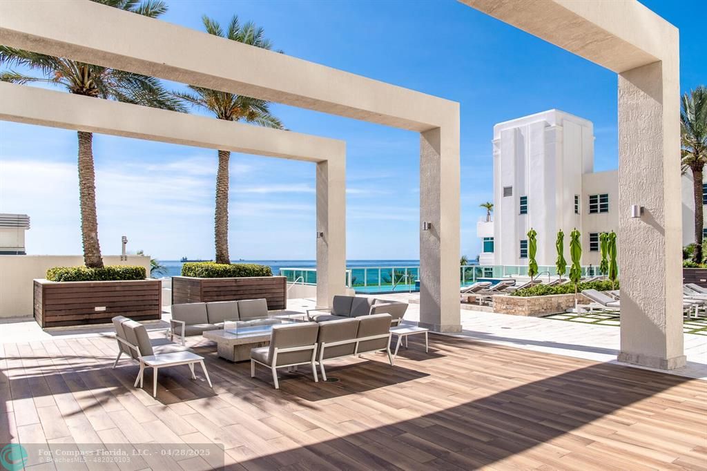 101 South Fort Lauderdale Beach Boulevard, Unit 1104 Fort Lauderdale, FL 33316 - Photo 29 of 41 a living room with patio furniture and floor to ceiling windows