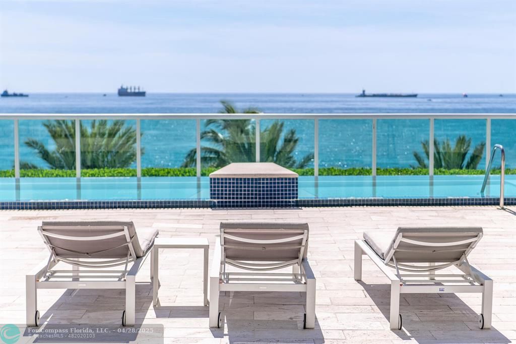 101 South Fort Lauderdale Beach Boulevard, Unit 1104 Fort Lauderdale, FL 33316 - Photo 34 of 41 a view of a chairs and table in patio with a yard