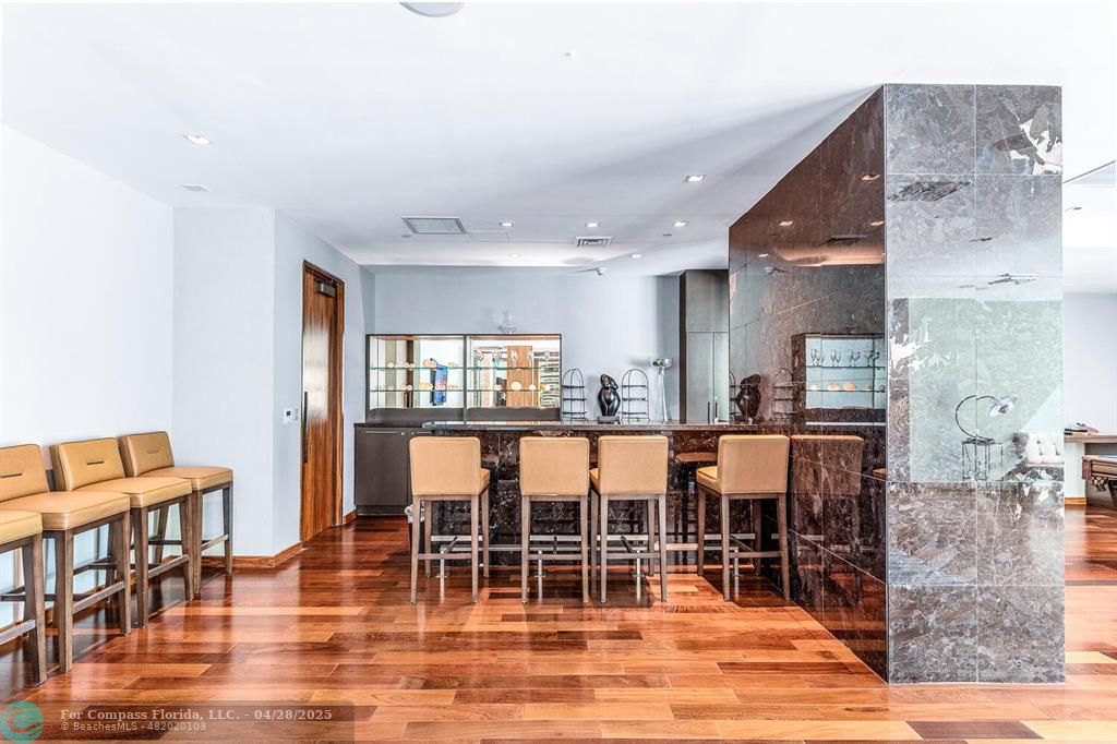 101 South Fort Lauderdale Beach Boulevard, Unit 1104 Fort Lauderdale, FL 33316 - Photo 37 of 41 a view of kitchen with dining area and wooden floor