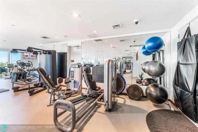 a room with gym equipment and windows