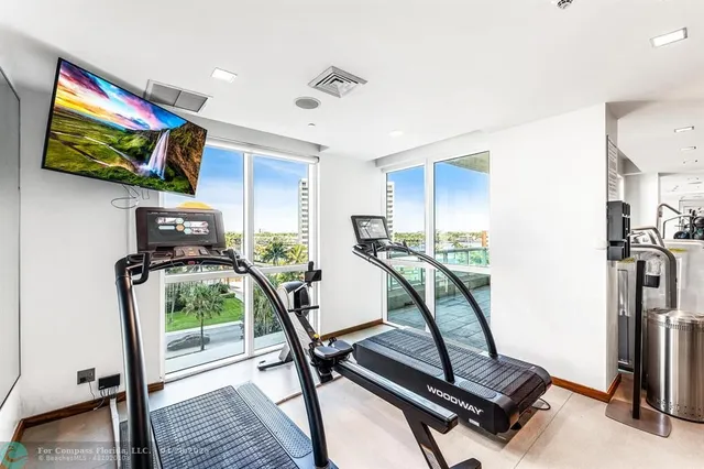 a view of a room with lots of gym equipment