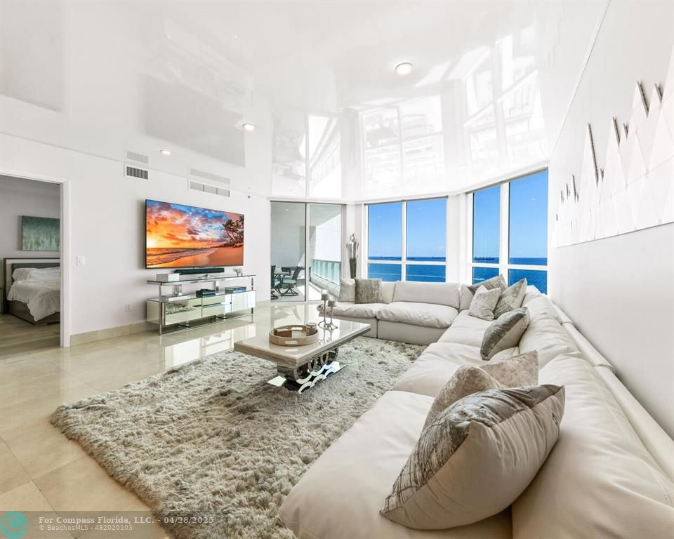 101 South Fort Lauderdale Beach Boulevard, Unit 1104 Fort Lauderdale, FL 33316 - Photo 7 of 41 a living room with furniture and a flat screen tv