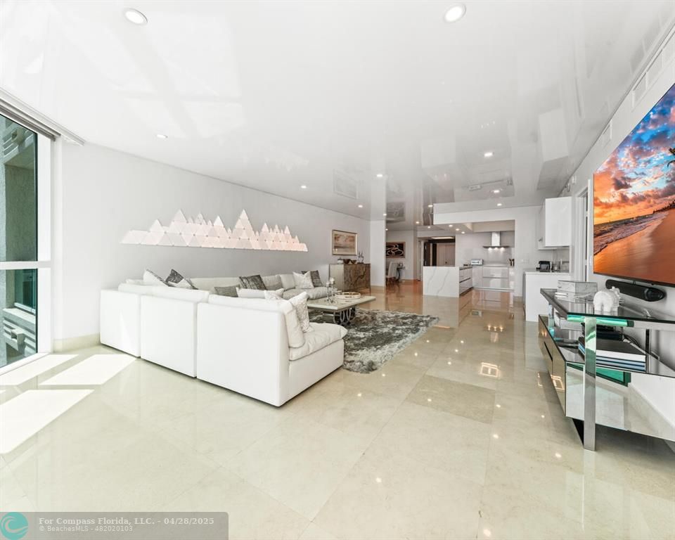 101 South Fort Lauderdale Beach Boulevard, Unit 1104 Fort Lauderdale, FL 33316 - Photo 8 of 41 a living room with furniture and a flat screen tv