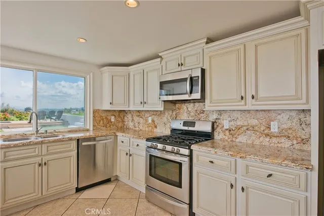 a kitchen with a sink and large window
