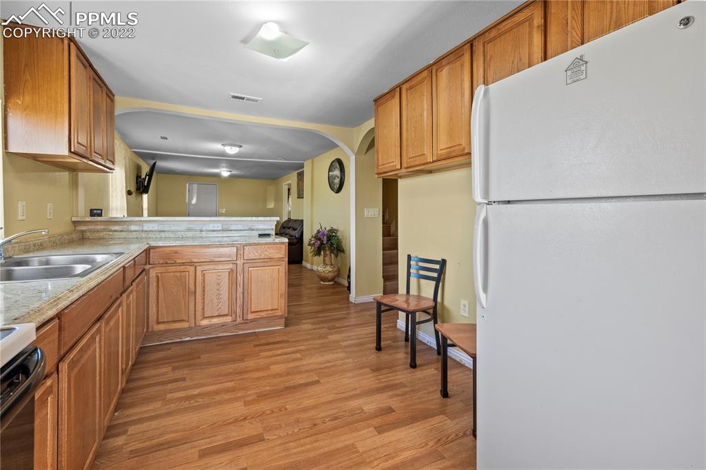 5025 Lauppe Road Yoder, CO 80864 - Photo 13 of 50 a kitchen with a refrigerator and a sink