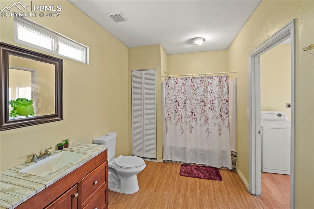 5025 Lauppe Road Yoder, CO 80864 - Photo 17 of 50 a bathroom with a granite countertop sink toilet and shower
