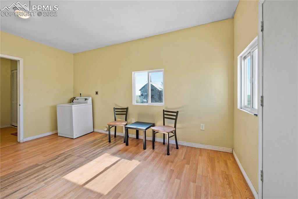 5025 Lauppe Road Yoder, CO 80864 - Photo 20 of 50 a view of a room with wooden floor and furniture