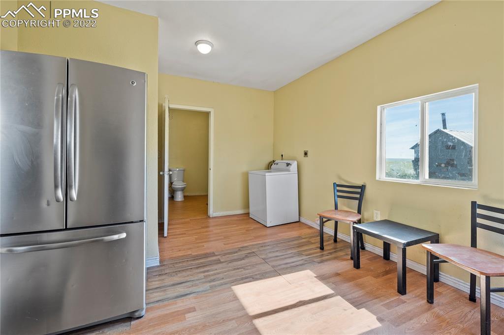 5025 Lauppe Road Yoder, CO 80864 - Photo 21 of 50 a view of a livingroom with furniture and a refrigerator