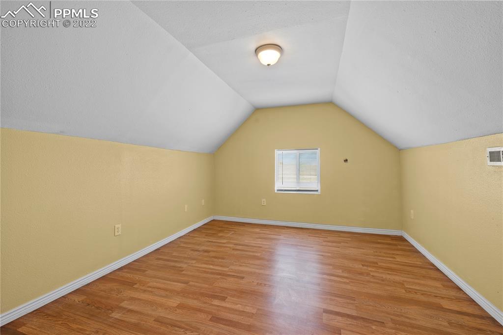 5025 Lauppe Road Yoder, CO 80864 - Photo 27 of 50 an empty room with wooden floor and windows
