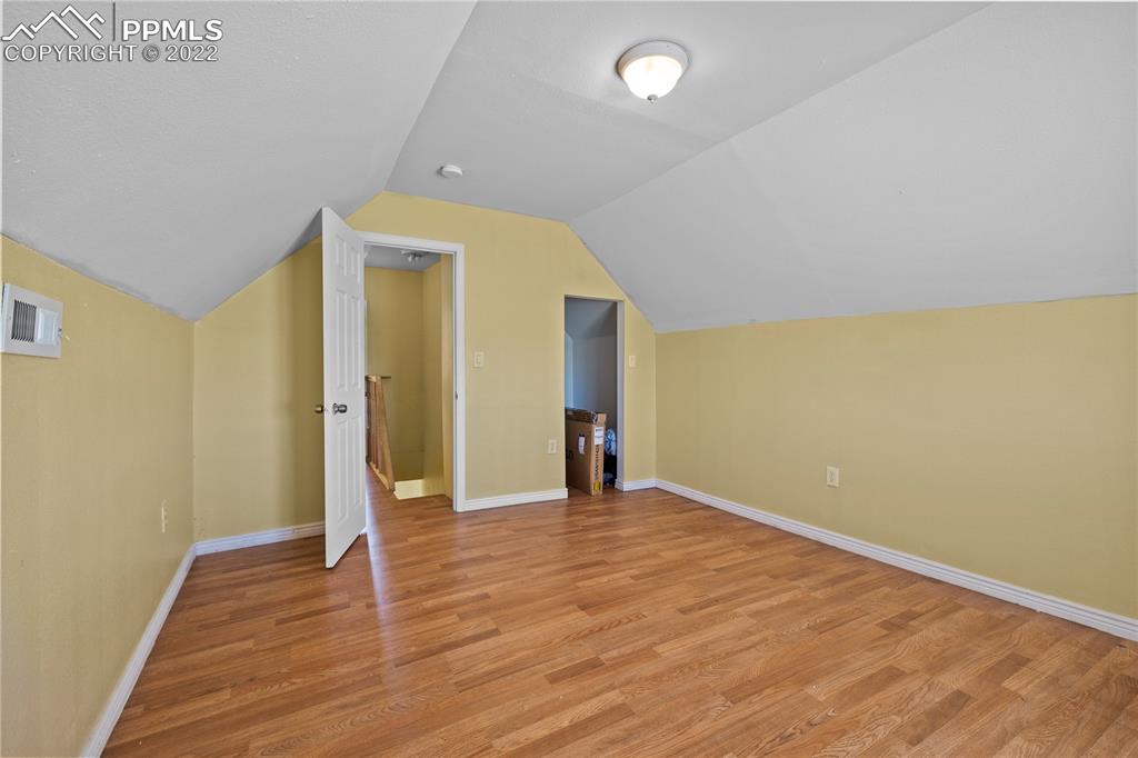 5025 Lauppe Road Yoder, CO 80864 - Photo 28 of 50 a view of an empty room with wooden floor