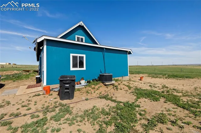 a front view of house with yard and ocean view