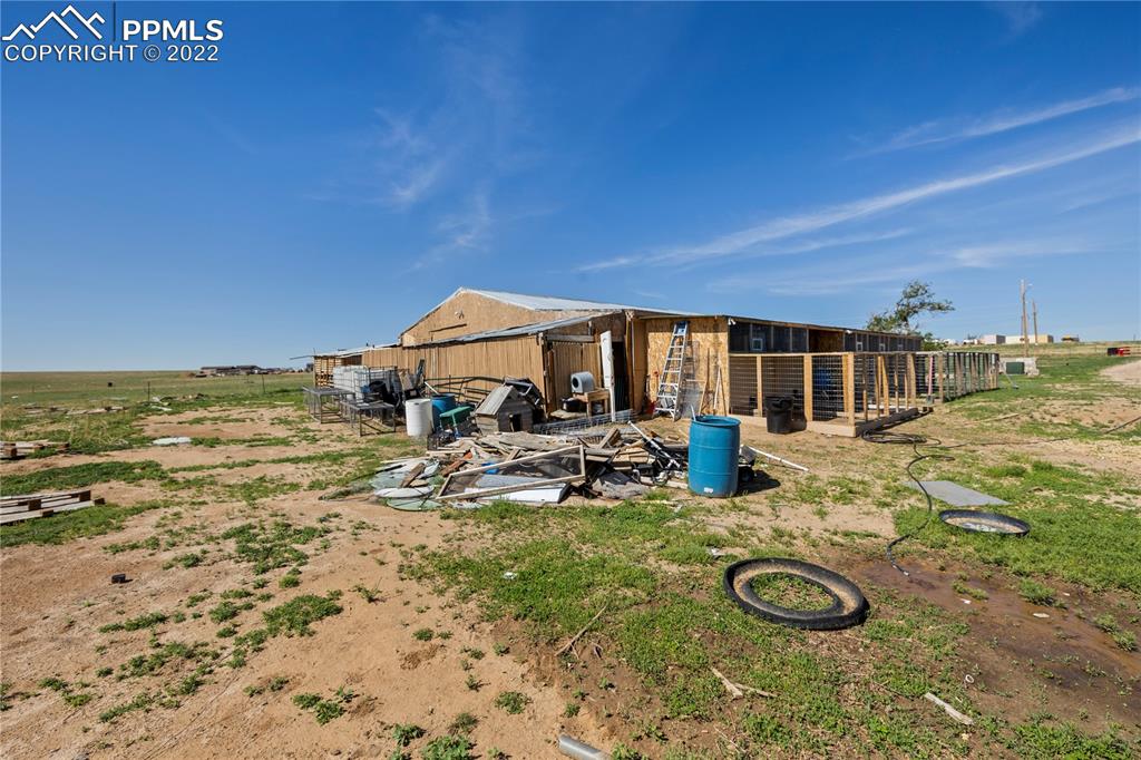 5025 Lauppe Road Yoder, CO 80864 - Photo 38 of 50 a view of a swimming pool with lawn chairs and plants