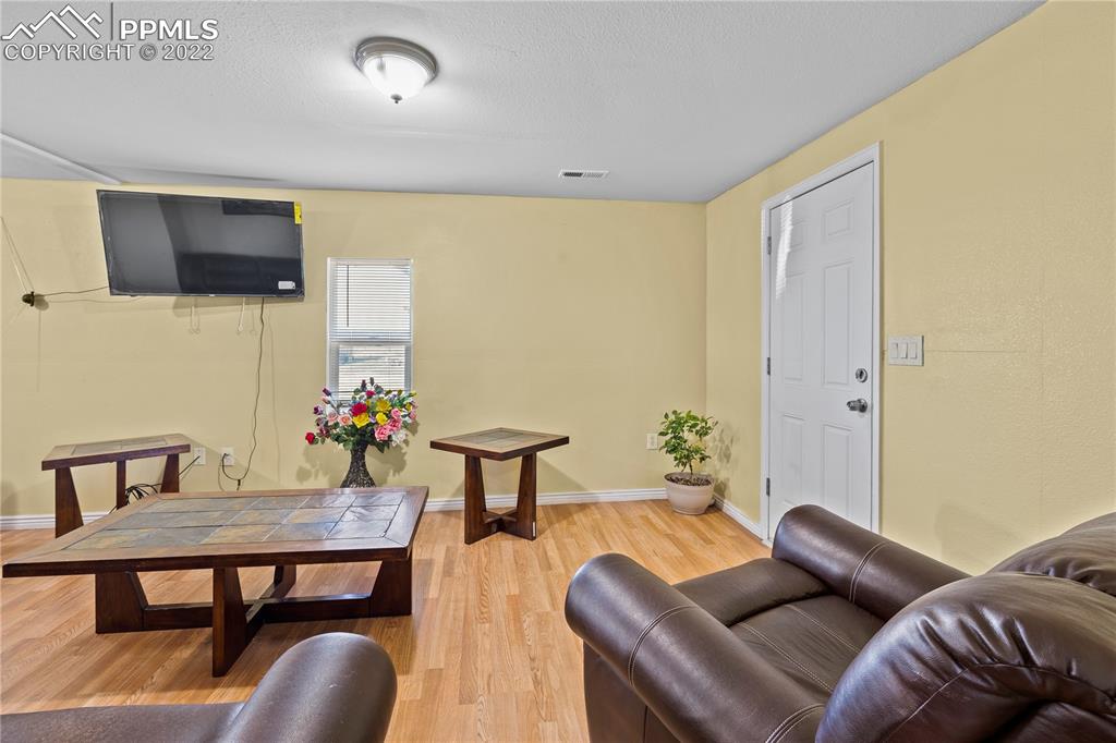 5025 Lauppe Road Yoder, CO 80864 - Photo 5 of 50 a living room with furniture and a flat screen tv