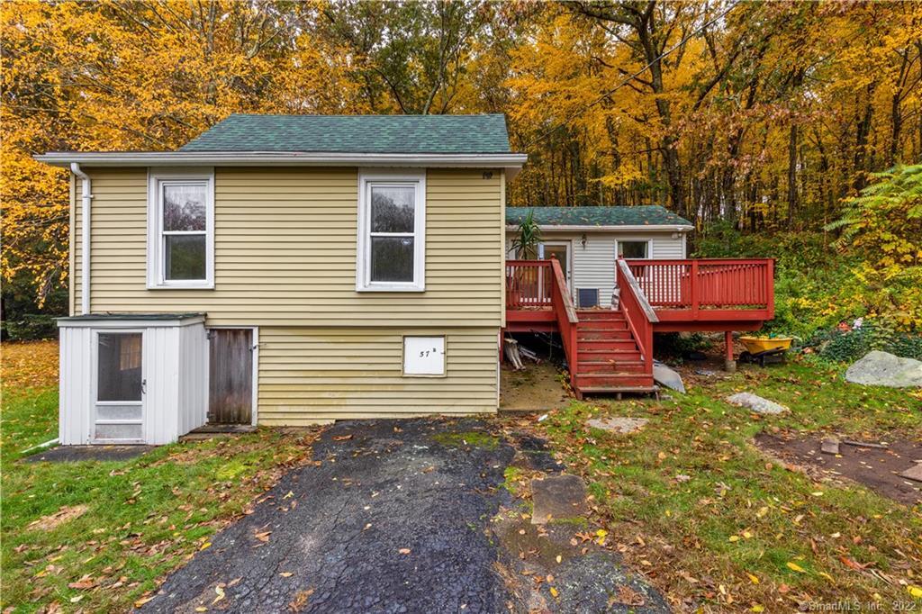 a view of a house with a yard and wooden fence