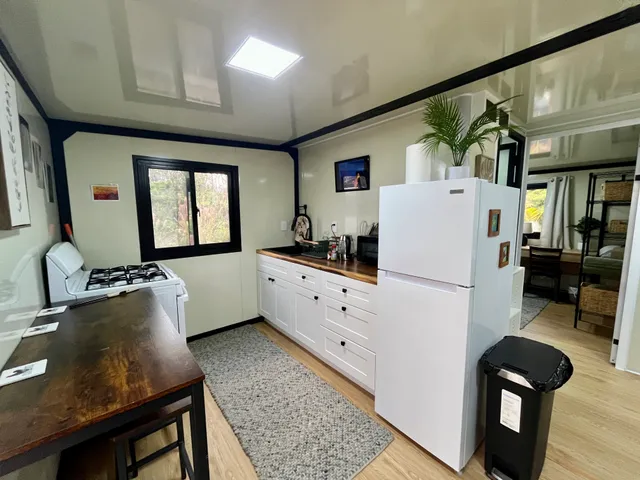 a kitchen with sink a refrigerator and furniture