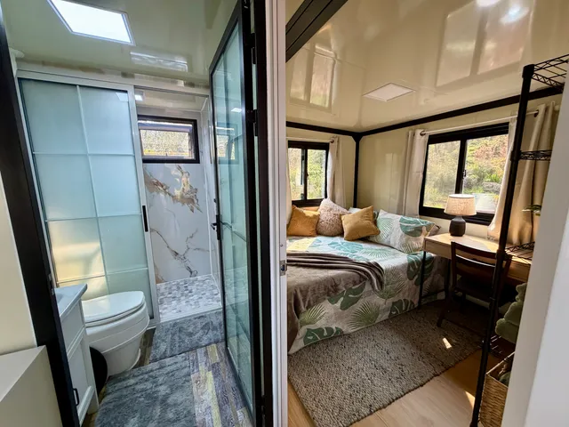 a bedroom with furniture and a large window