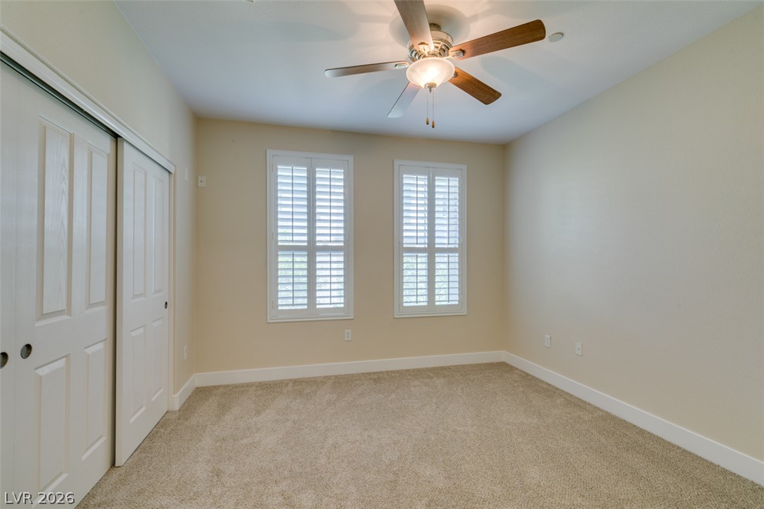 2555 Hampton Road, Unit 3203 Henderson, NV 89052 - Photo 32 of 43 Plush carpeting and classic plantation shutters define this versatile secondary bedroom space.